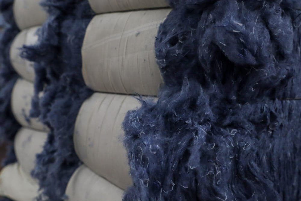 Bales of recycled indigo fibre ready for spinning